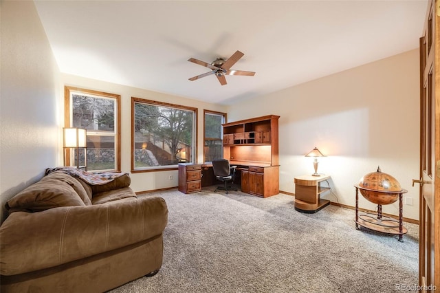 office area with light colored carpet, baseboards, and ceiling fan