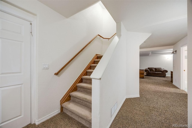 stairs featuring visible vents, baseboards, and carpet floors