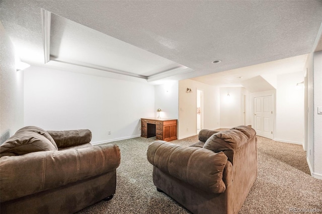 living room featuring a tray ceiling, baseboards, and carpet