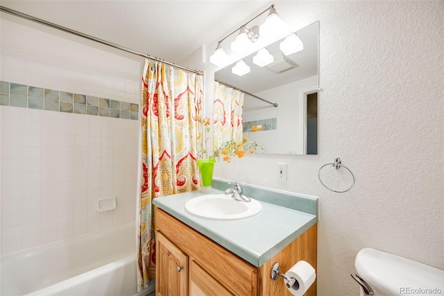 bathroom featuring vanity, shower / tub combo, toilet, and a textured wall