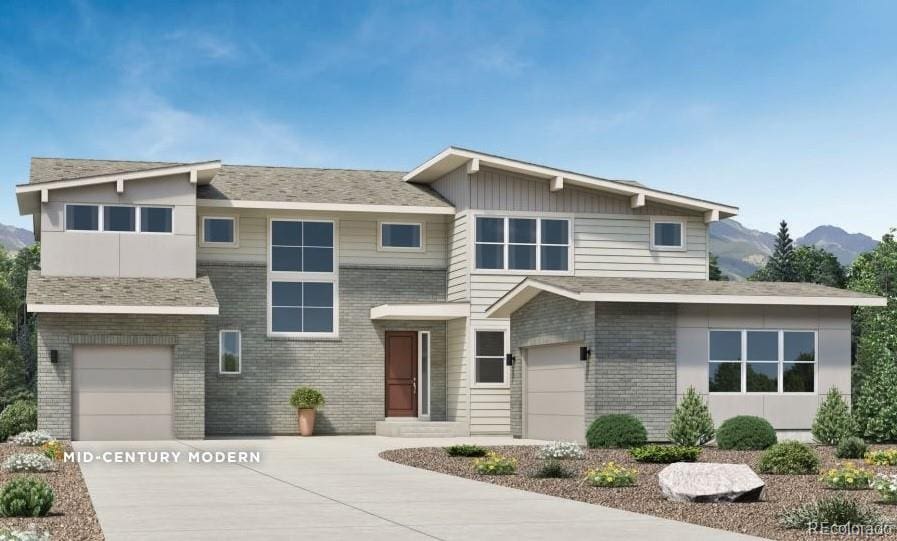 view of front of property with a mountain view and a garage