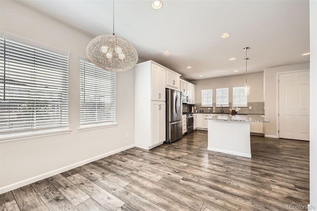 kitchen with stainless steel appliances, a chandelier, white cabinets, recessed lighting, and dark wood finished floors