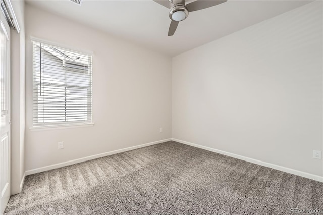 carpeted empty room with healthy amount of natural light, baseboards, and a ceiling fan