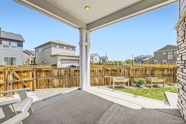 view of patio featuring a residential view and fence