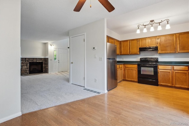 kitchen featuring black electric range, freestanding refrigerator, under cabinet range hood, dark countertops, and a ceiling fan