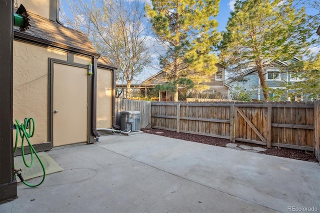 view of patio / terrace with central air condition unit and a fenced backyard
