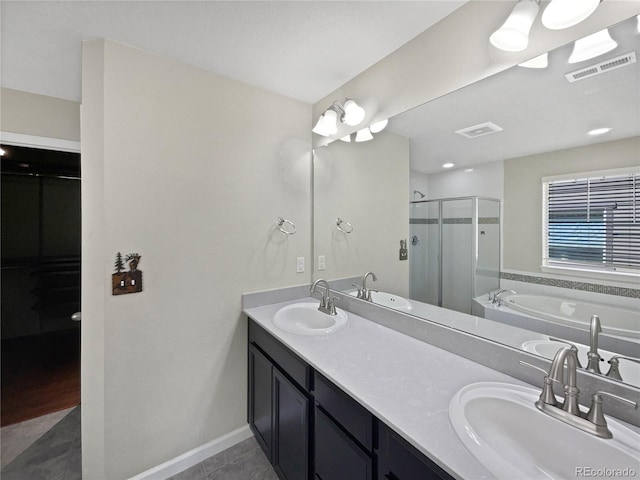 full bath with a shower stall, a sink, and visible vents