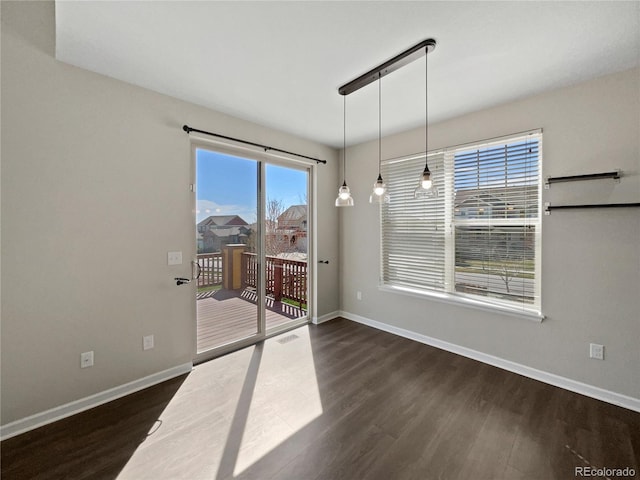 dining space featuring baseboards, visible vents, and dark wood-style floors