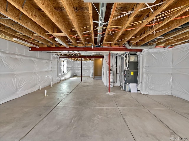 unfinished basement featuring gas water heater and heating unit