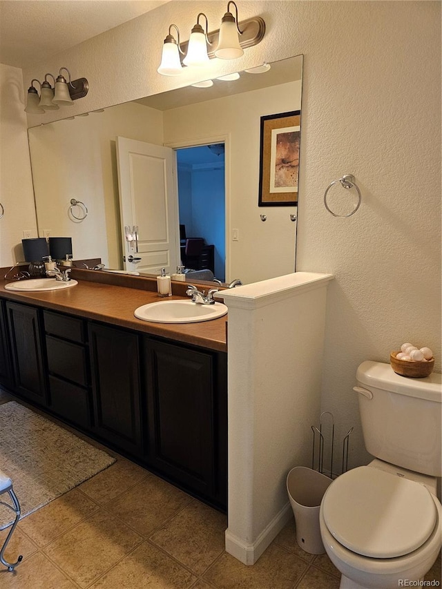 bathroom with tile patterned floors, vanity, and toilet