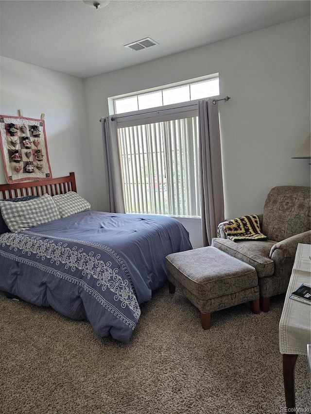 carpeted bedroom featuring multiple windows