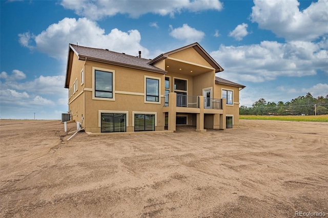 back of property featuring a balcony