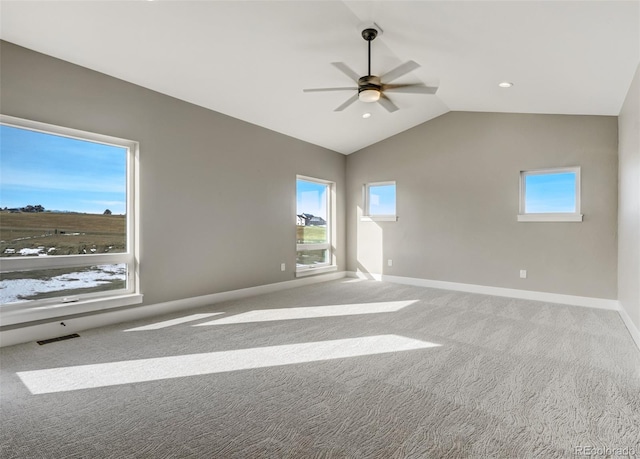 empty room with vaulted ceiling, ceiling fan, and carpet