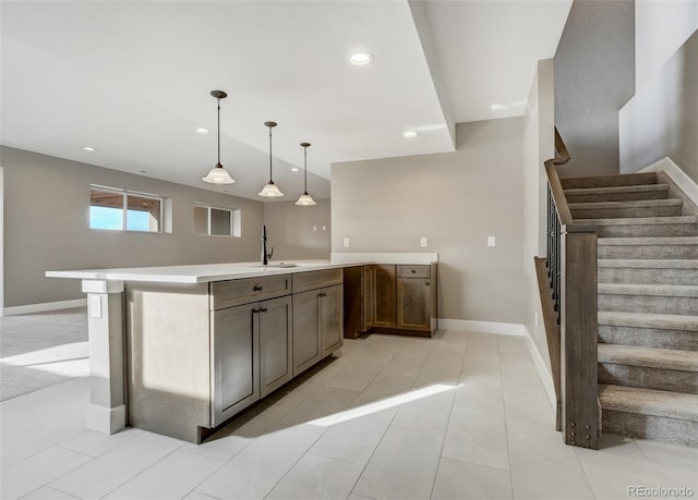 kitchen featuring pendant lighting, light tile patterned flooring, and sink