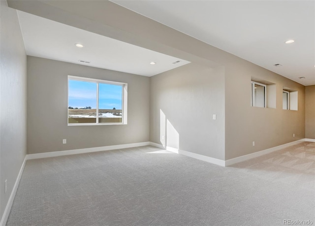 unfurnished room with light carpet