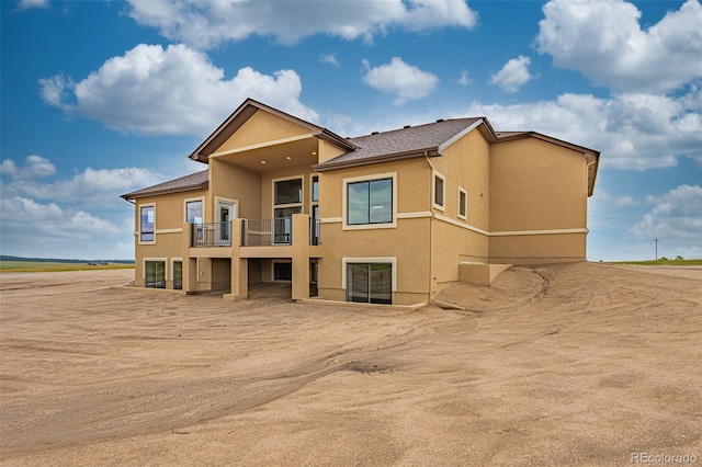 rear view of property with a balcony