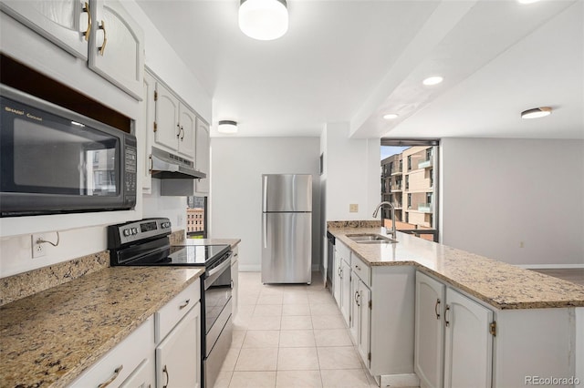 kitchen with appliances with stainless steel finishes, a sink, baseboards, a peninsula, and under cabinet range hood