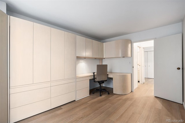 office space featuring built in study area and light wood finished floors