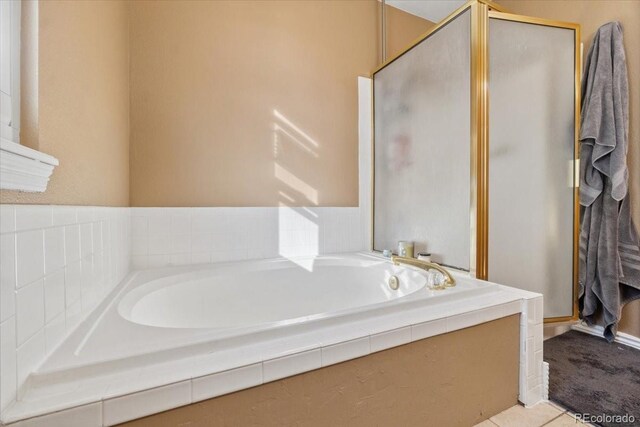 180 S Carlton St, Castle Rock, CO 80104 - bathroom featuring a shower stall and a garden tub
