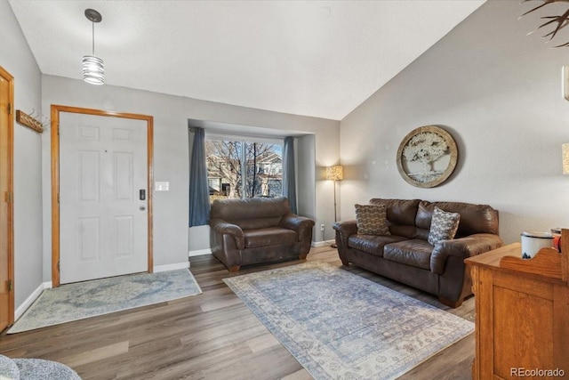 180 S Carlton St, Castle Rock, CO 80104 - living area featuring vaulted ceiling, baseboards, and light wood finished floors