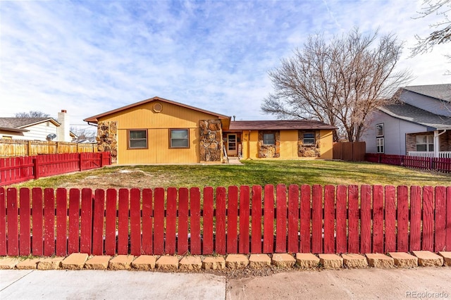 ranch-style house with a front lawn