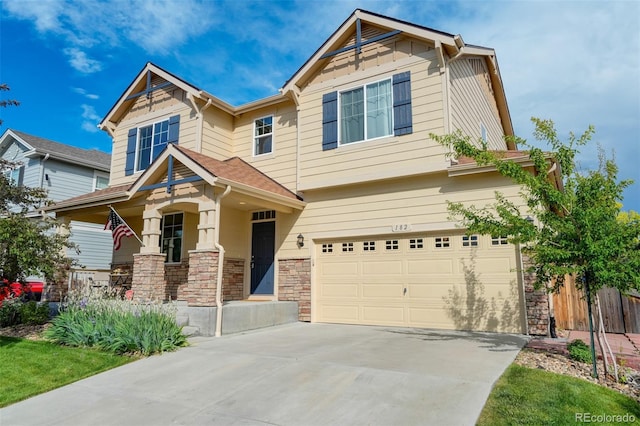 craftsman-style house featuring covered porch and a garage