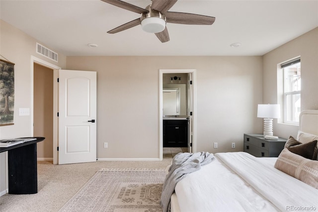 carpeted bedroom featuring ceiling fan and ensuite bathroom