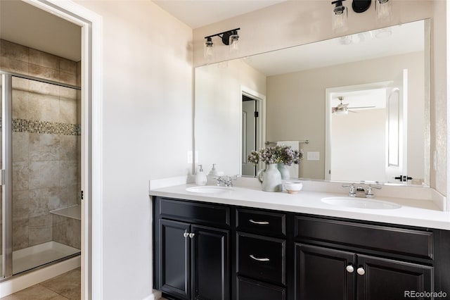 bathroom featuring ceiling fan, vanity, tile patterned flooring, and a shower with door