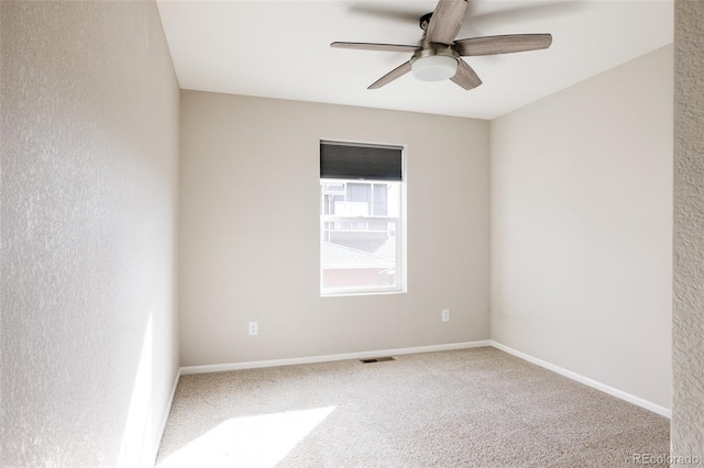 spare room featuring carpet floors and ceiling fan