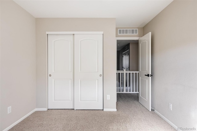 unfurnished bedroom featuring a closet and carpet