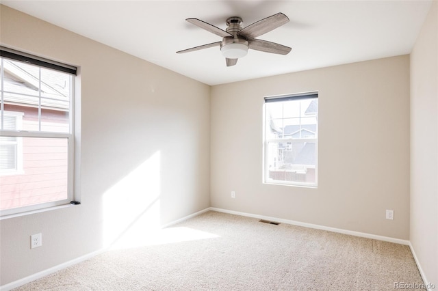 unfurnished room featuring ceiling fan and carpet flooring