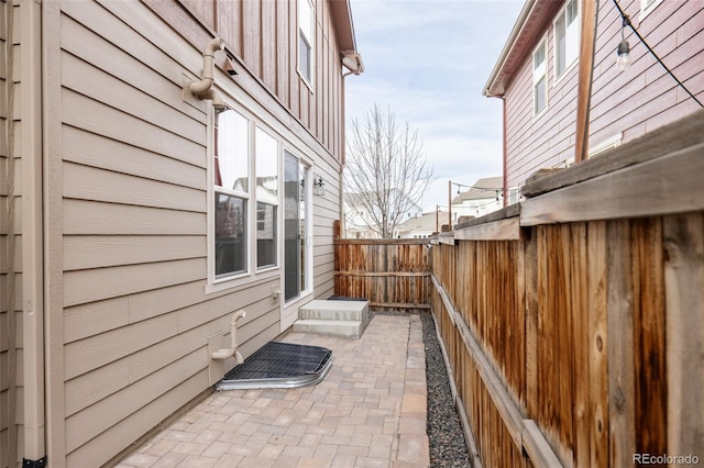 view of side of home with a patio area