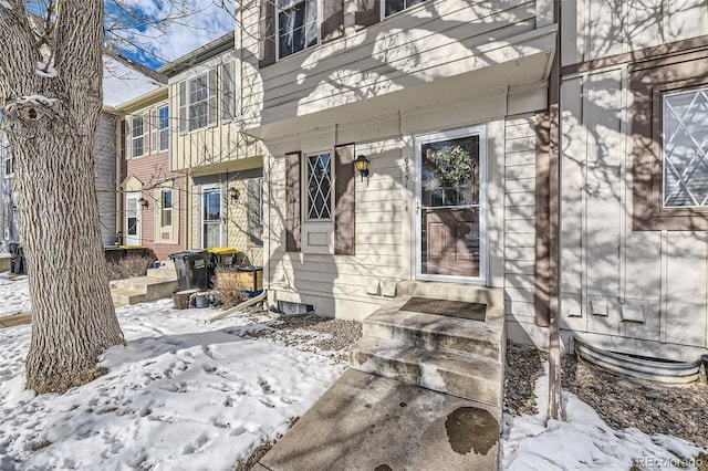 view of snow covered property entrance