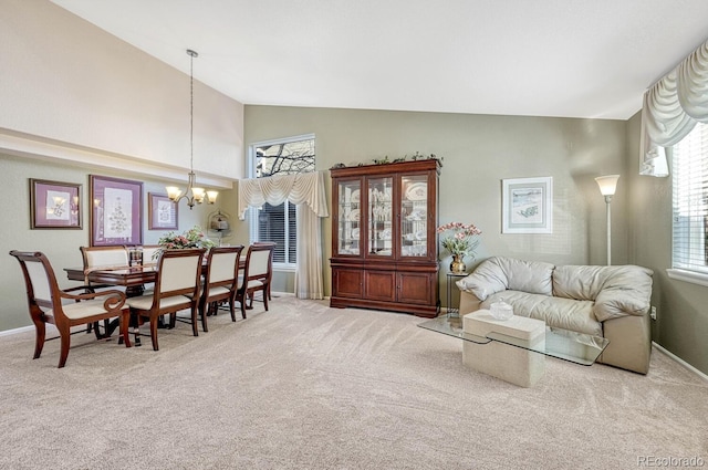 living room with high vaulted ceiling, carpet, and a notable chandelier