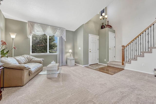 carpeted living room with a notable chandelier