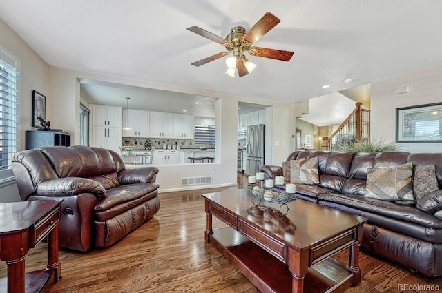 living room with ceiling fan and wood-type flooring