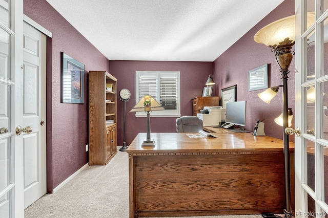 office area with light carpet, a textured ceiling, and french doors