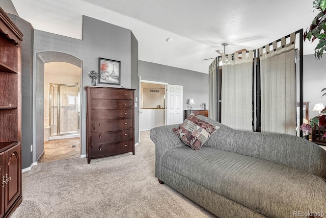 living room featuring light carpet, vaulted ceiling, and ceiling fan