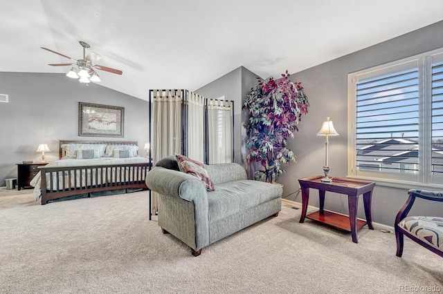 bedroom featuring ceiling fan, light colored carpet, and vaulted ceiling