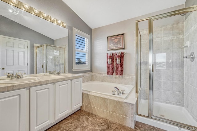 bathroom with vanity, vaulted ceiling, and plus walk in shower