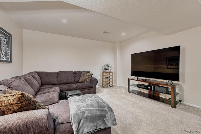 carpeted living room featuring a textured ceiling