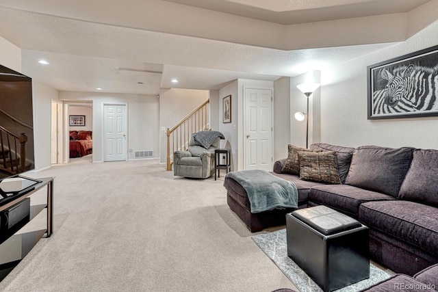 living room with a textured ceiling and carpet