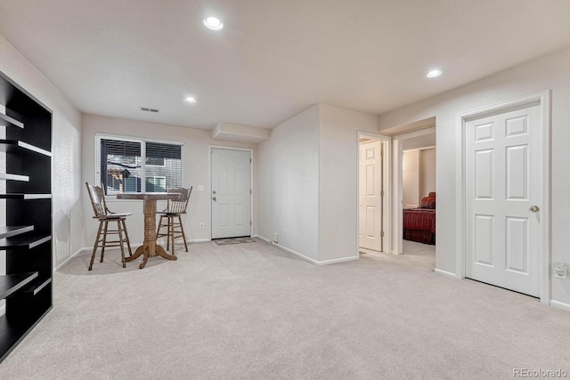 interior space featuring bar area and light carpet