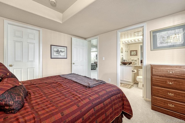 carpeted bedroom with ensuite bath