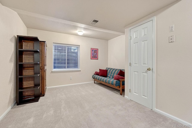 living area with light carpet