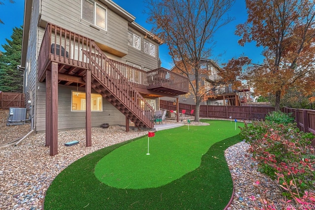 back of property featuring a deck and central AC