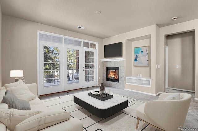 living room with a fireplace and light carpet