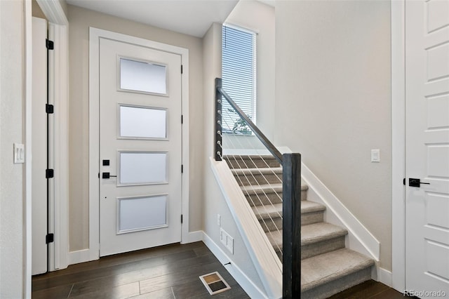 11350 W Grand Ave, Littleton, CO 80127 - foyer entrance with visible vents, baseboards, stairs, and dark wood finished floors