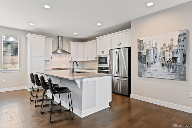 11350 W Grand Ave, Littleton, CO 80127 - kitchen featuring dark wood-style flooring, a sink, wall chimney exhaust hood, and stainless steel appliances