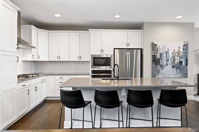 11350 W Grand Ave, Littleton, CO 80127 - kitchen with dark wood finished floors, tasteful backsplash, appliances with stainless steel finishes, a sink, and a breakfast bar area